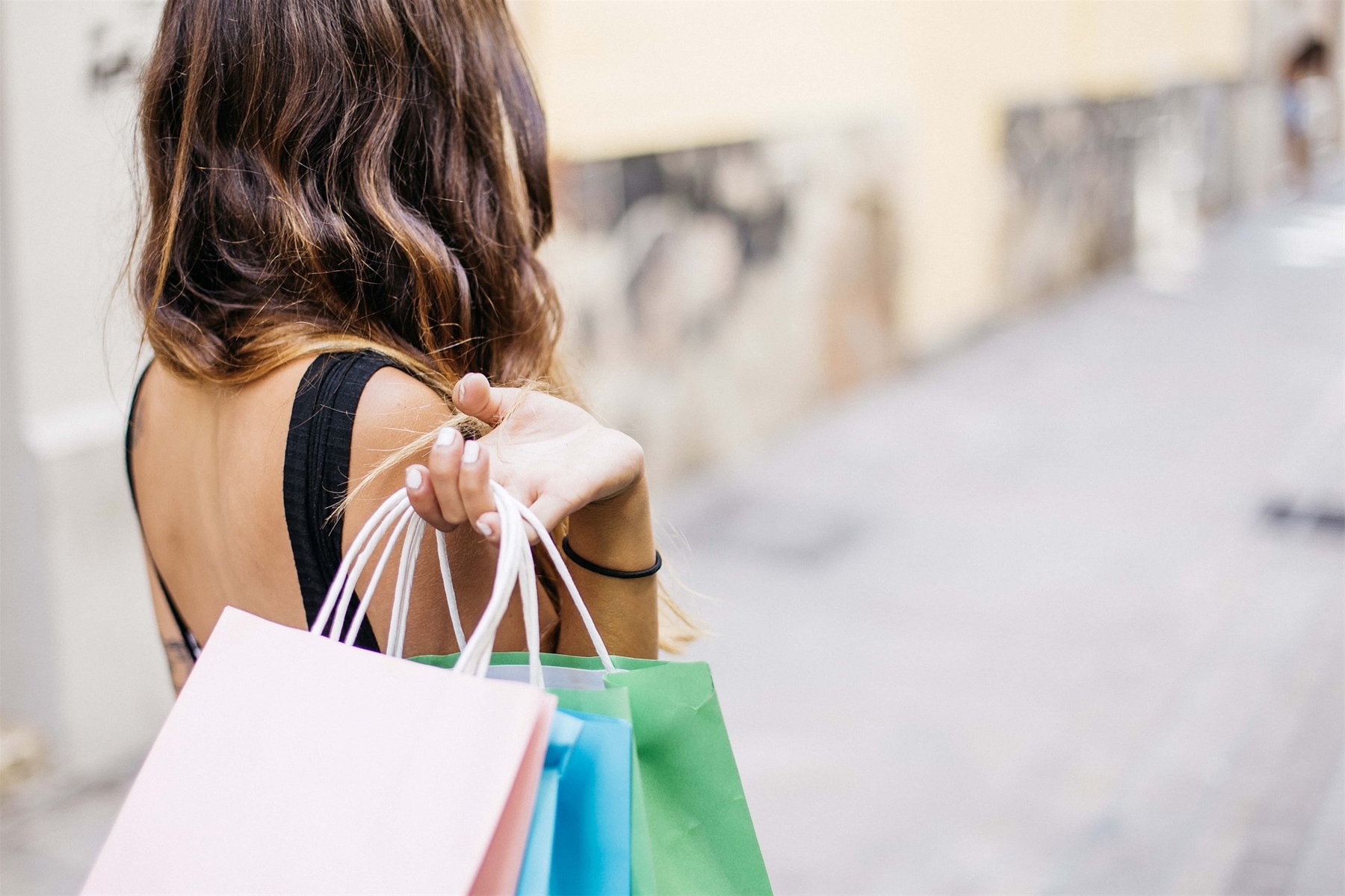 Women Holding Shopping Backs Over Her Sholder